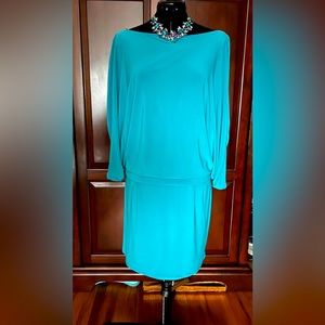 Stylish, sexy dress in a beautiful turquoise color with sneak peek of back